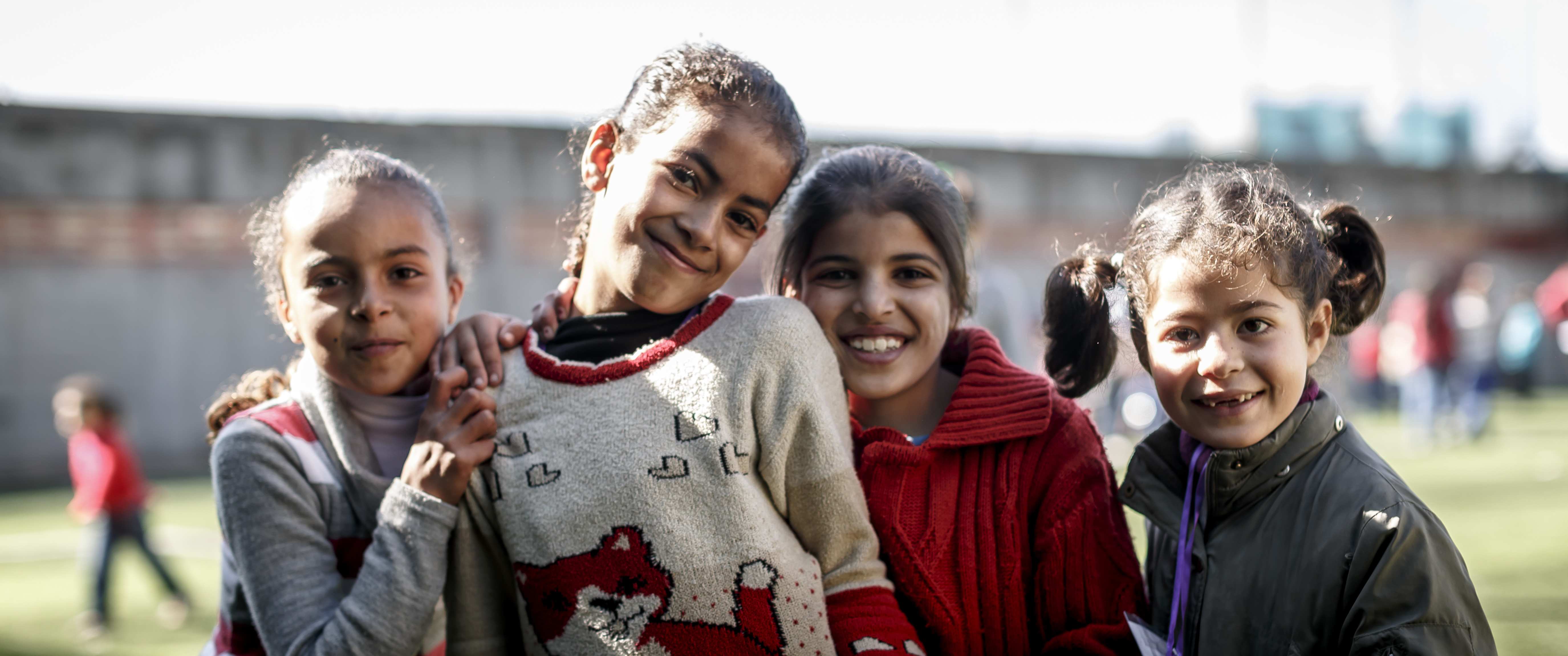 Eine Gruppe von Mädchen stehen zusammen und lächeln. Foto: Jakob Studnar