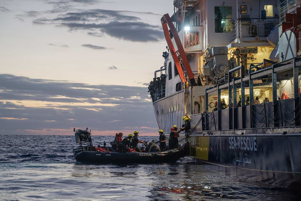 Ein Schlauchboot legt am Schiff an, Menschen werden an Bord gezogen (Quelle: Arez Ghaderi/OS Humanity)