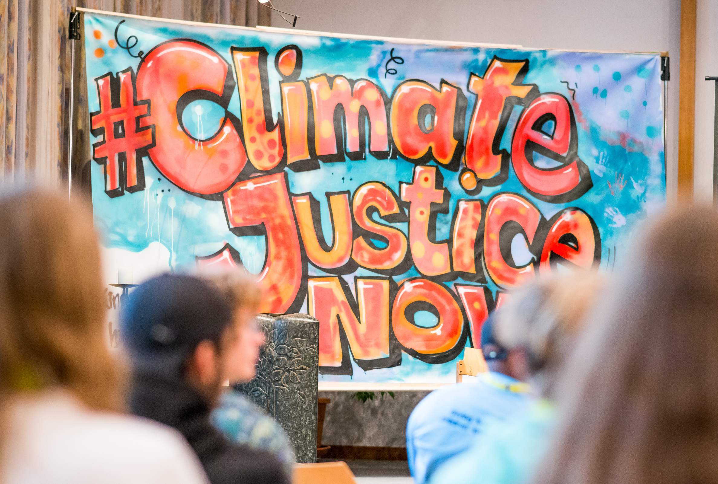 Banner mir der Aufschrift "Climate Justice Now" Banner mir der Aufschrift "Climate Justice Now"