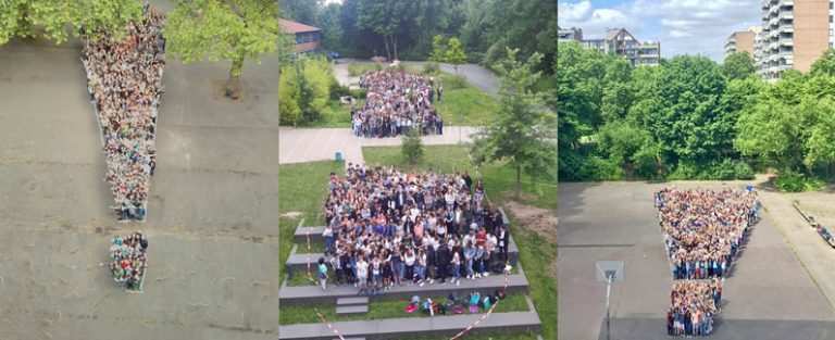 Menschen formen gemeinsam ein großes Ausrufezeichen (Quelle: Kindernothilfe)