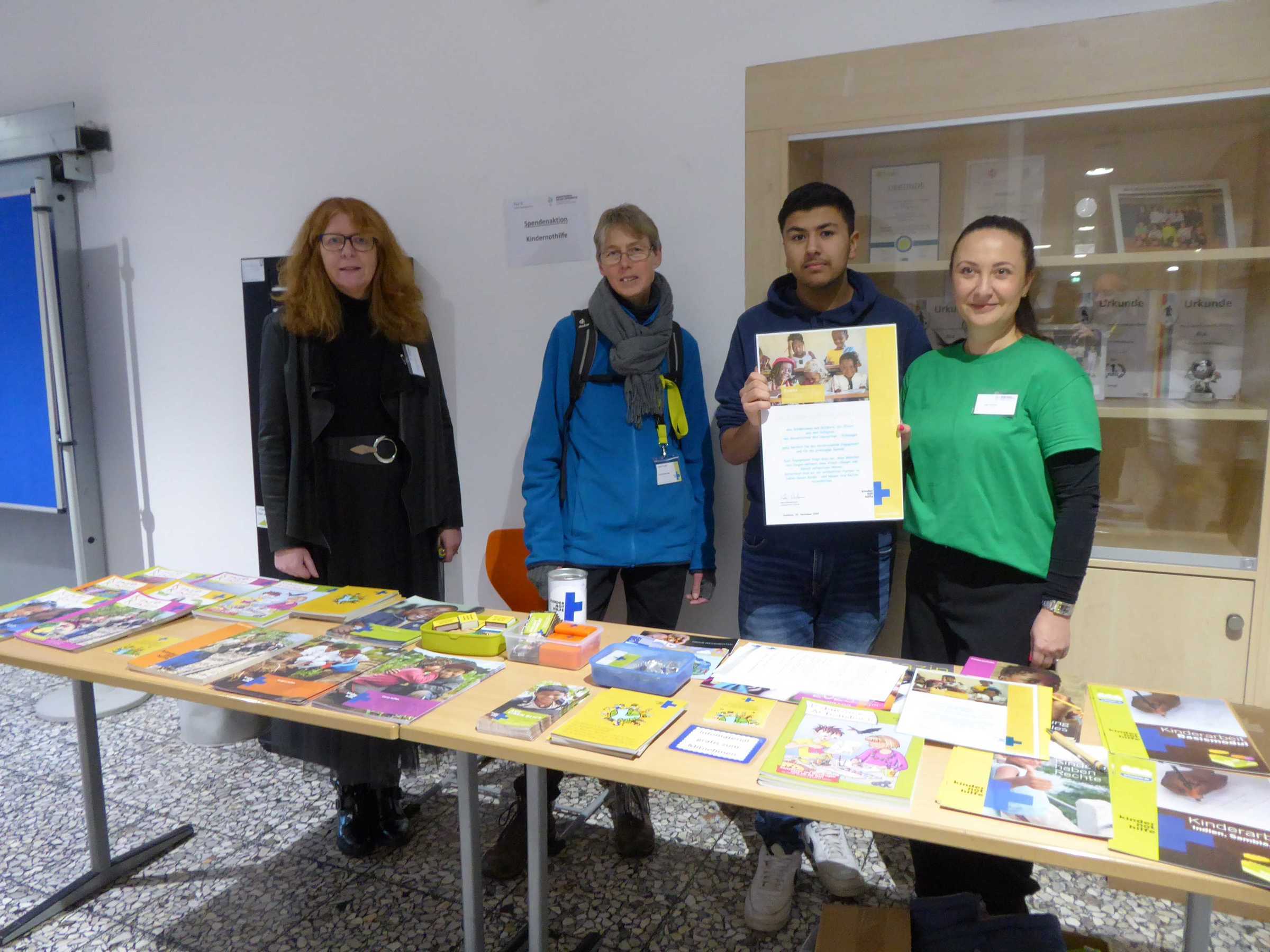 Vier Personen stehen hinter einem Kindernothilfe-Infostand (Quelle: privat)