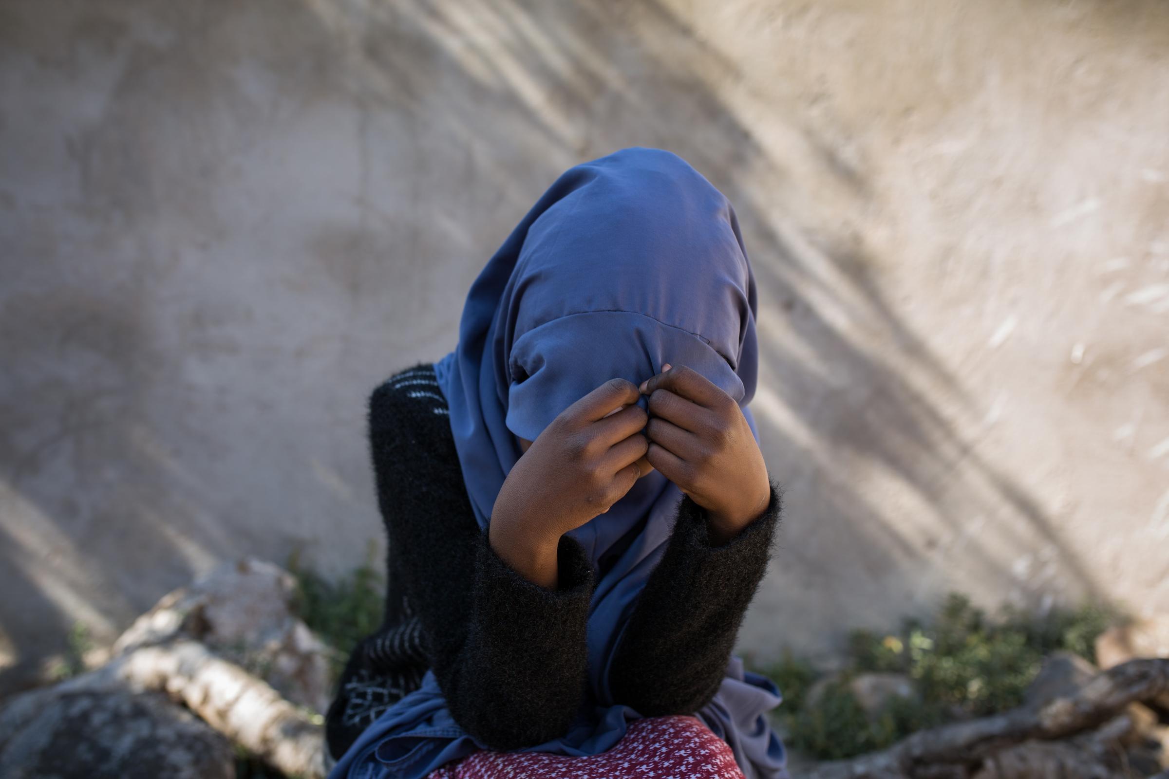 Ein Mädchen mit Kopftuch schaut nach unten und hält ihre Hände vor dem Gesicht (Quelle: ©2021 Mustafa Saeed, All Rights Reserved) Ein Mädchen mit Kopftuch schaut nach unten und hält ihre Hände vor dem Gesicht (Quelle: ©2021 Mustafa Saeed, All Rights Reserved)