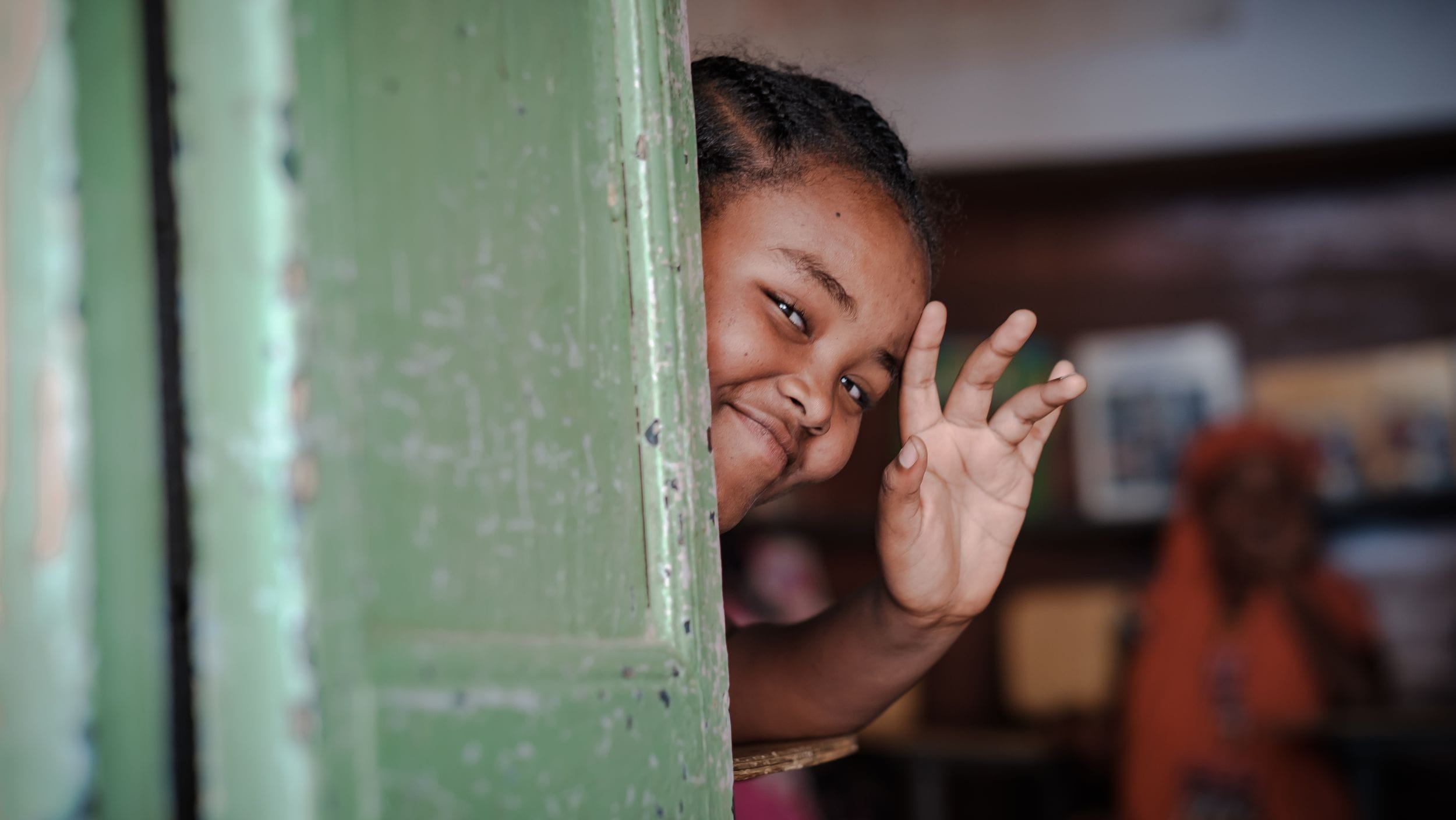 Ein äthiopisches Mädchen blickt aus der Haustür und winkt. (Quelle: Jakob Studnar) Ein äthiopisches Mädchen blickt aus der Haustür und winkt. (Quelle: Jakob Studnar)