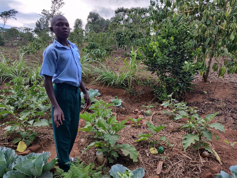 Ein Farmschüler aus Uganda zeigt stolz, was er in der Schule gelernt hat. (Quelle: Katharina Drzisga)