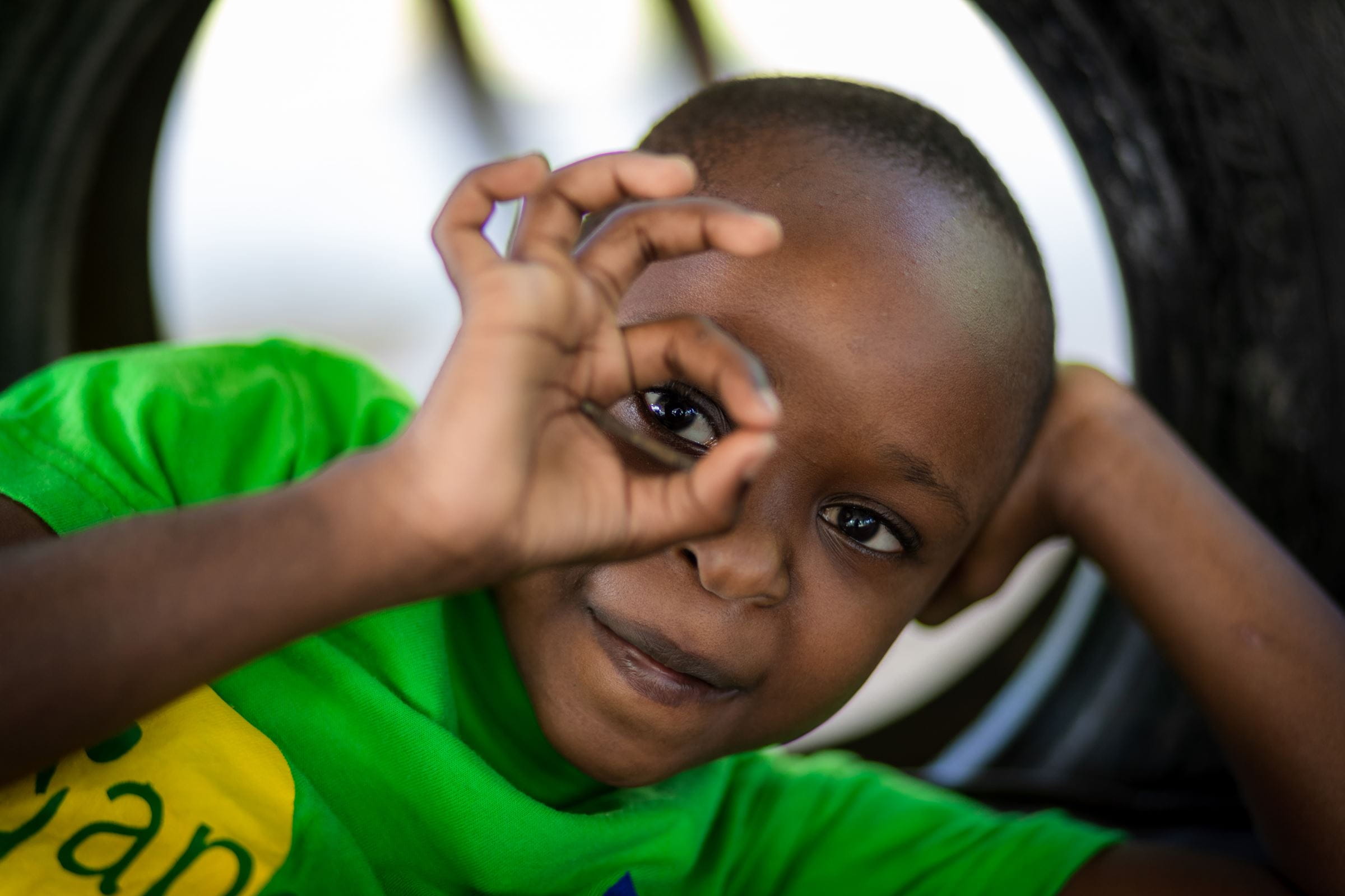 Ein Junge schaut durch seine Finger - Kenia, Mombasa (Quelle: Lars Heidrich)