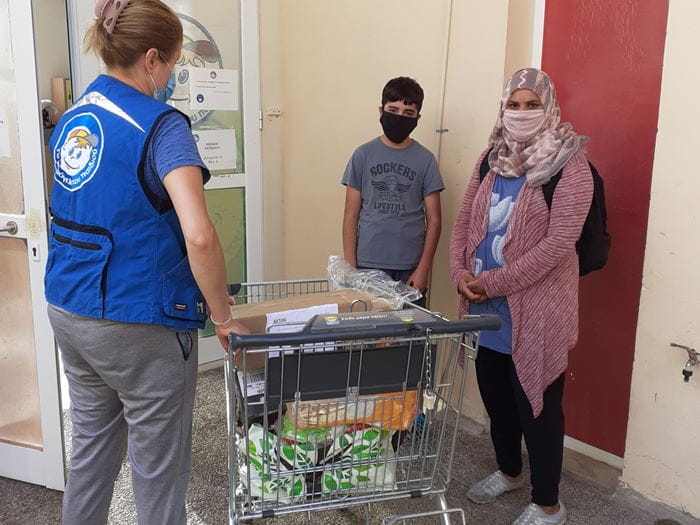 Eine Frau und ein Mann, Geflüchtete in Griechenland, erhalten Lebensmittel im Kindernothilfe-Projekt. (Quelle: Lena Bakatsi)
